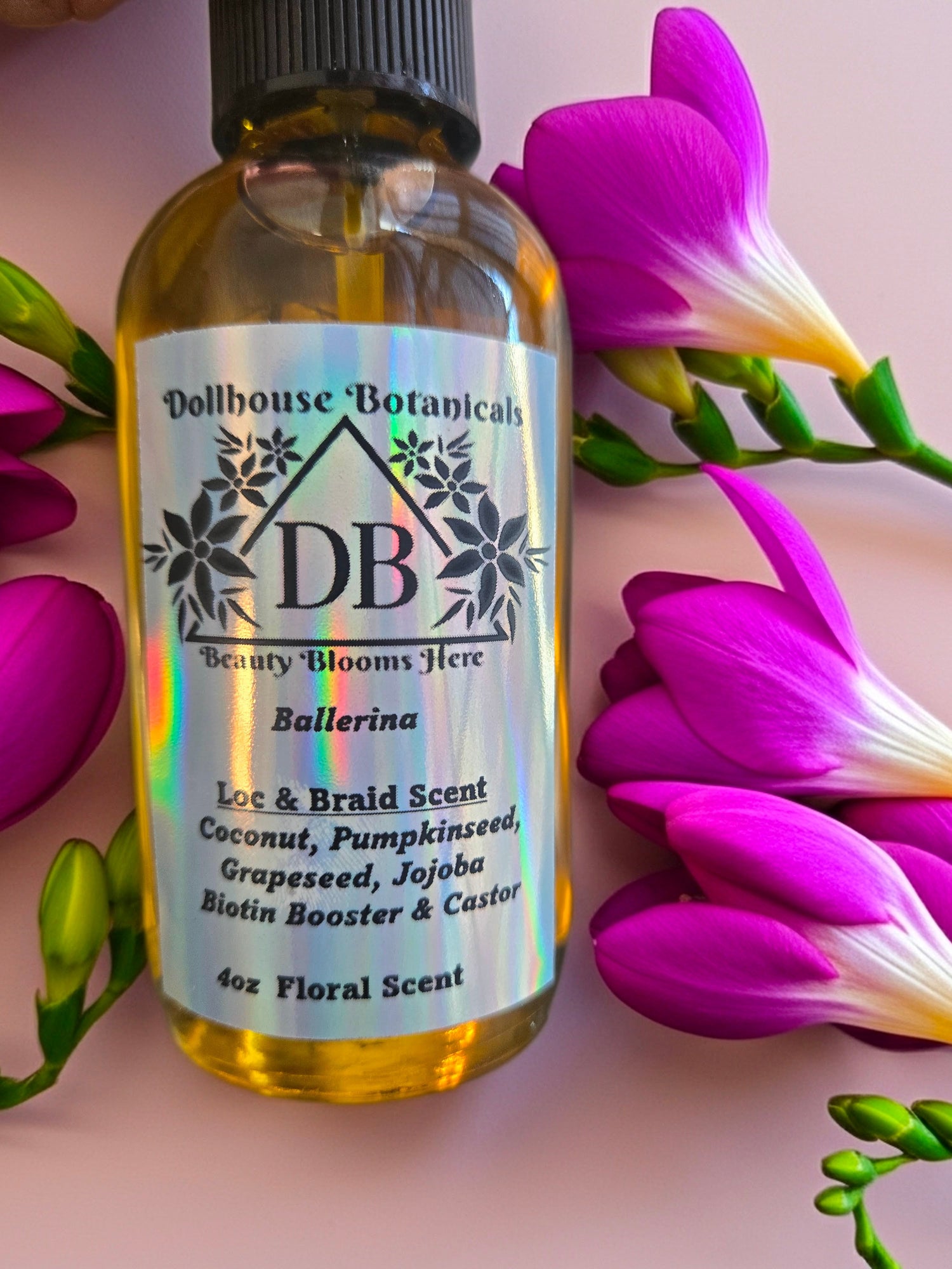 Bottle of Dollhouse Botanicals Bay Rum Loc and Beard Scent, held up by hand.