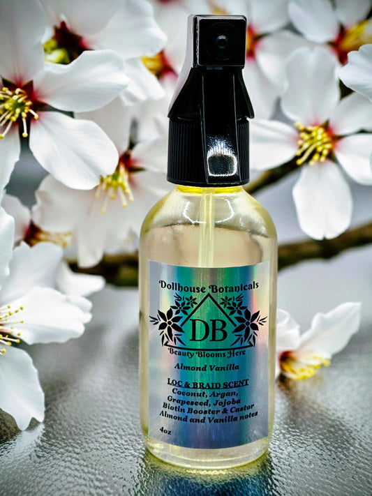 Bottle of Dollhouse Botanicals Loc and Braid Scent. Oil in clear glass bottle with black trigger sprayer applicator. Feminine hair perfume.