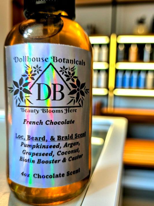 Dollhouse Botanicals French Chocolate Loc, Beard, and Braid Scent. Golden oil in glass bottle. Front facing with label and ingredients displayed. Unisex hair fragrance.