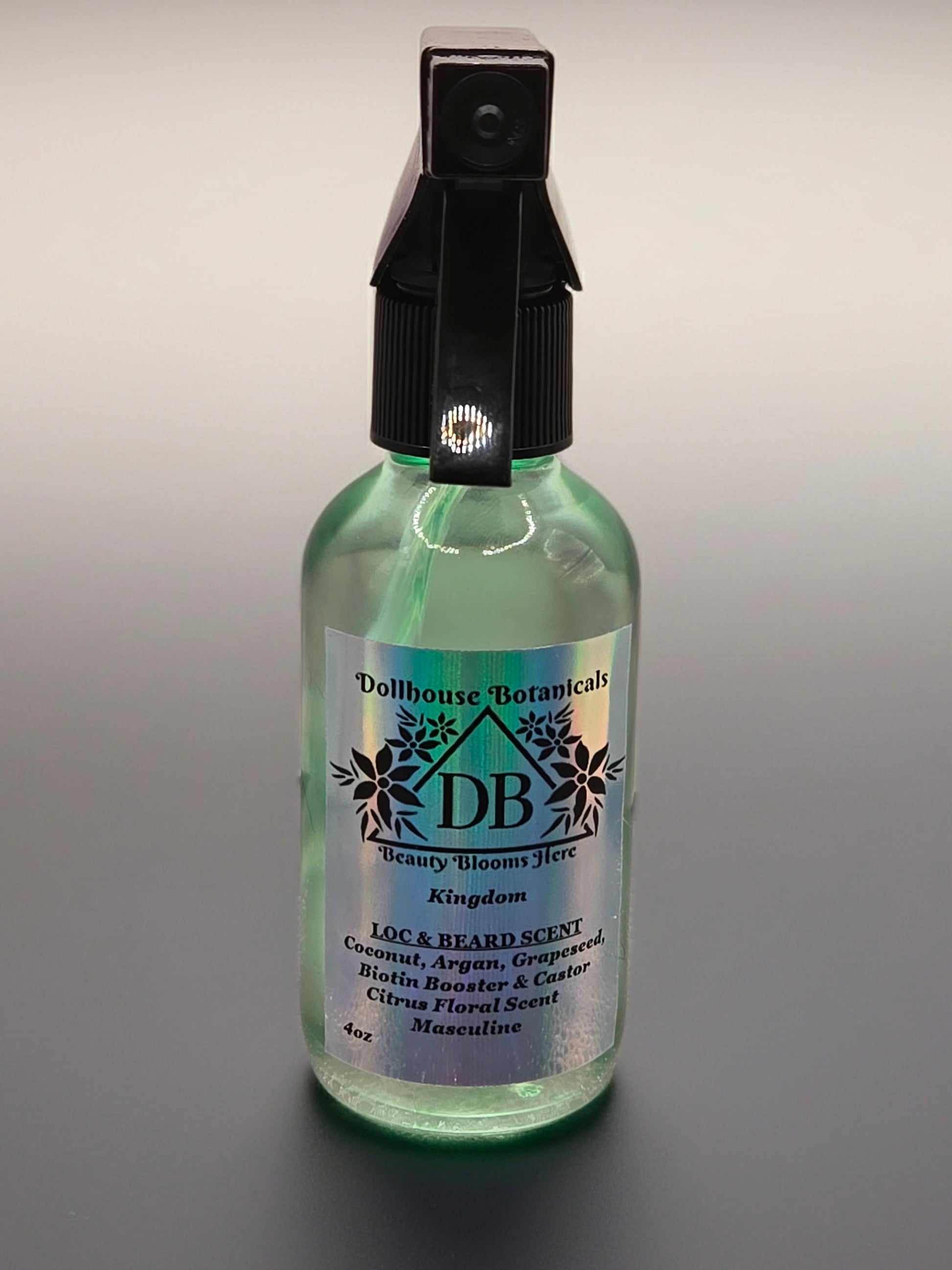 Bottle of Dollhouse Botanicals Kingdom Loc and Beard Scent. Oil in glass bottle with trigger sprayer. Masculine hair fragrance.