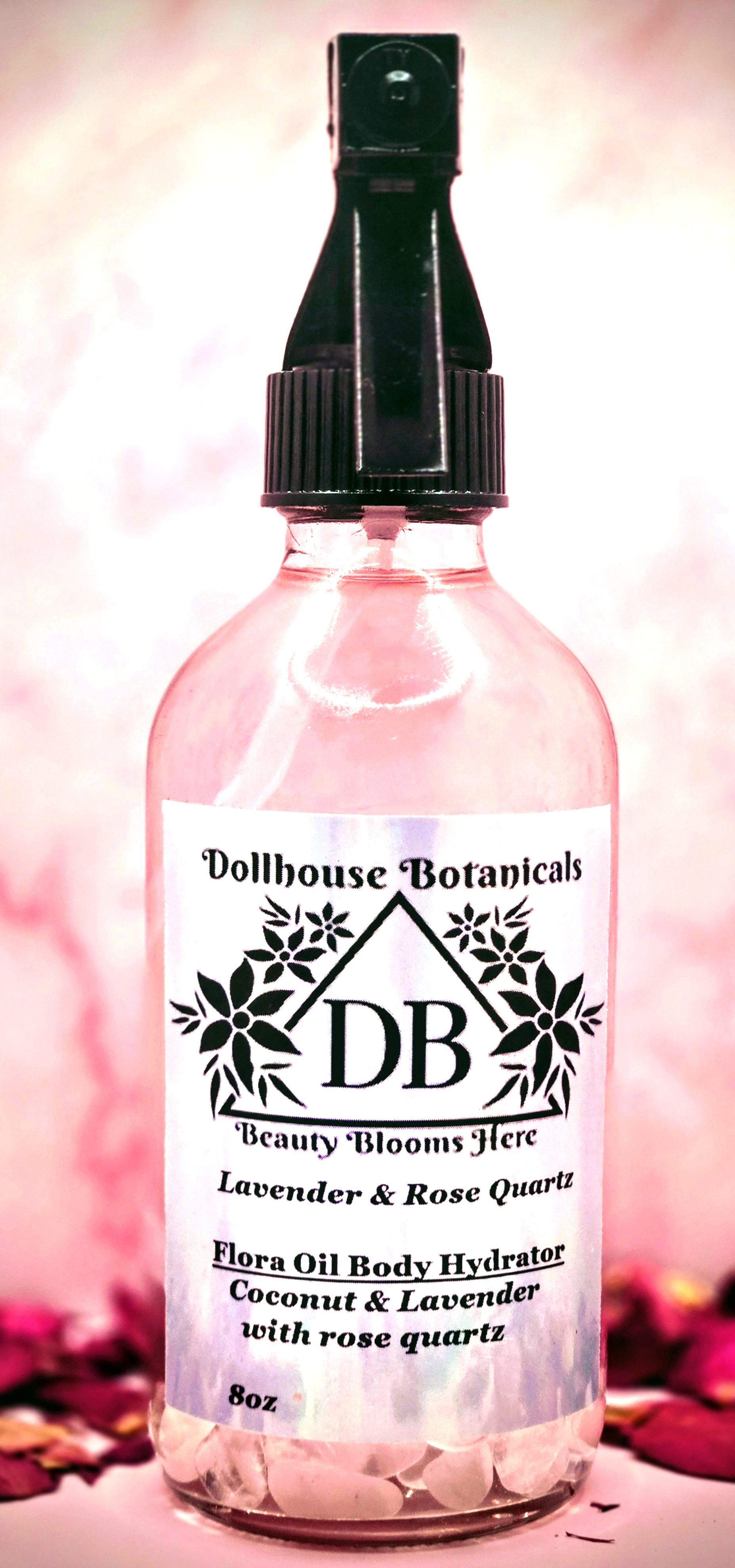 Dollhouse Botanicals Lavender and Rose Quartz Flora Oil Body Hydrator botanical oil in pink glass bottle with black sprayer
