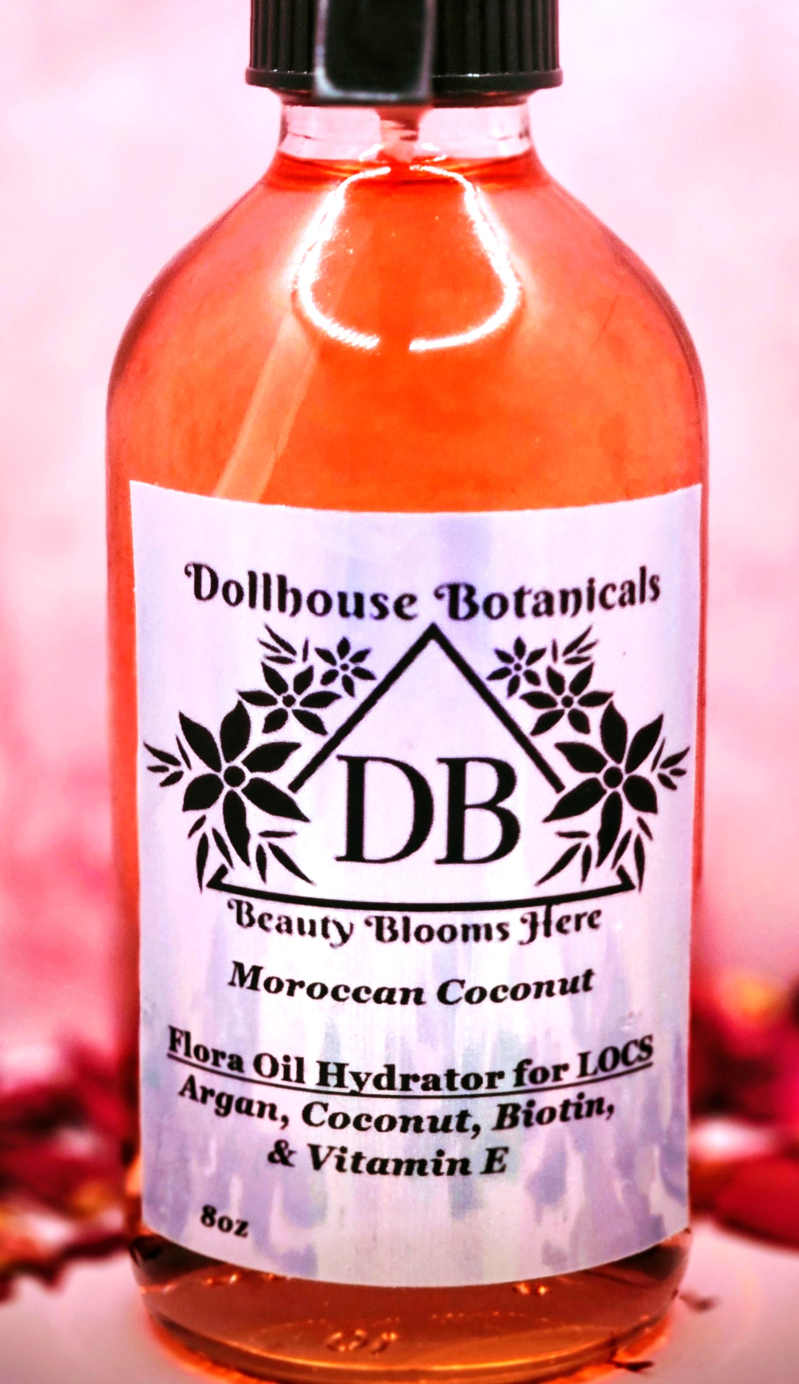 Dollhouse Botanicals Moroccan Coconut Flora Oil Hydrator for locs in pink glass bottle with black sprayer