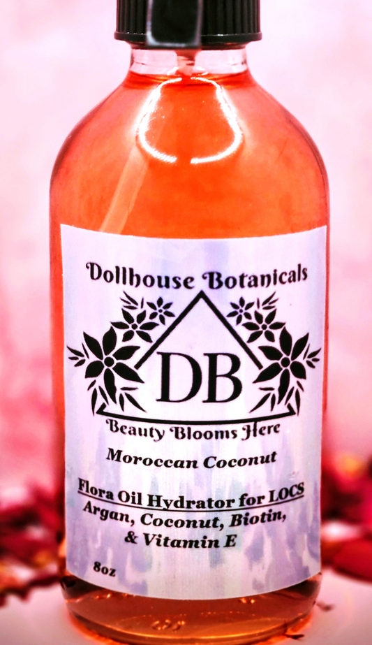 Dollhouse Botanicals Moroccan Coconut Flora Oil Hydrator for locs in pink glass bottle with black sprayer