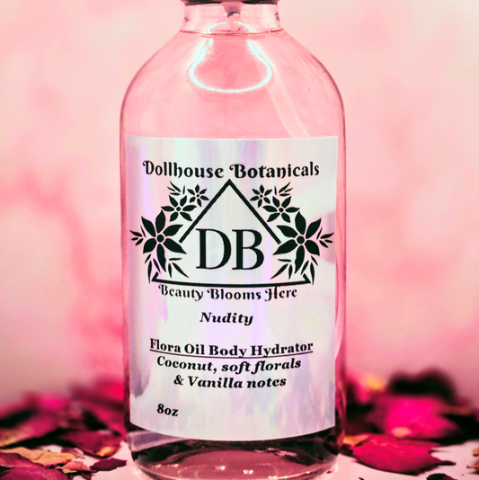 Dollhouse Botanicals Nudity Flora Oil Body Hydrator botanical oil in pink glass bottle with black sprayer