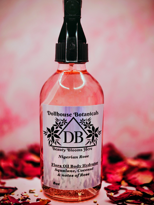 Dollhouse Botanicals Nigerian Rose Flora Oil Body Hydrator botanical oil in pink glass bottle with black sprayer
